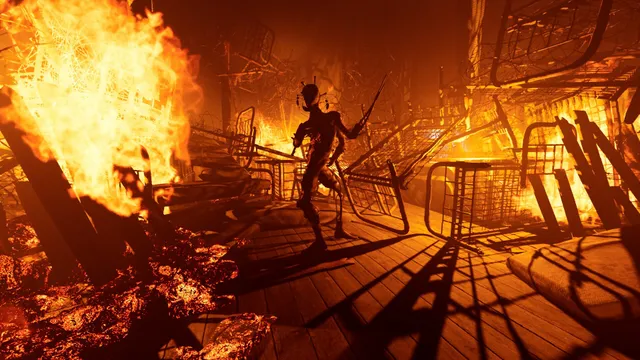 A thin creature with blades stalks through a room of burning bed frames