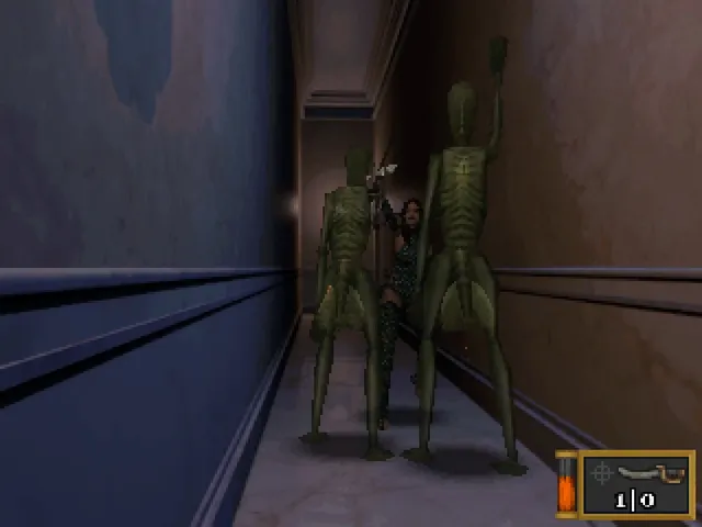 Two thin green doll-like creatures stand in a narrow blue corridor in front of Alisa, with the ammunition counter in the corner