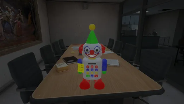 A toy clown robot with a keypad on its chest standing on a conference table