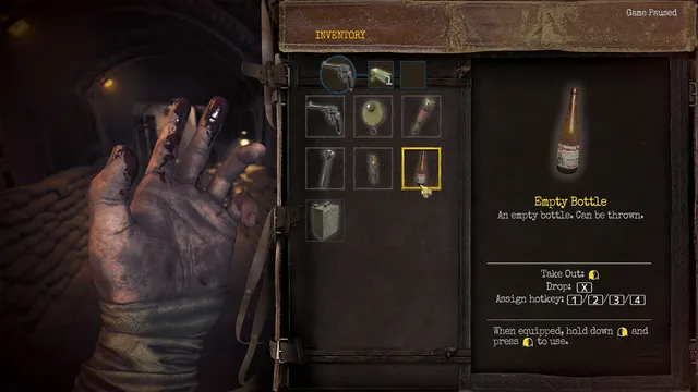 Amnesia: The Bunker screenshot: the inventory open beside a bloodied hand, showing a revolver, tools and an empty bottle that can be thrown