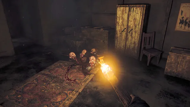 Amnesia: The Bunker screenshot: a burning torch held over a writhing cluster of rats on a bloody rug