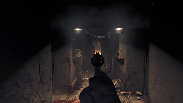 Amnesia: The Bunker screenshot: aiming a revolver down a dim bunker corridor with blood on the floor and two lamps overhead
