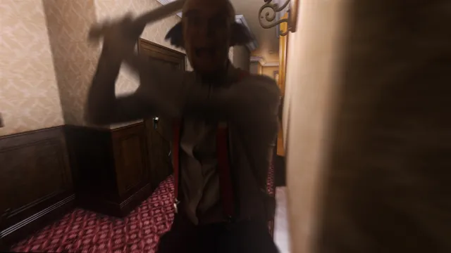 A blurred, wild-eyed man in braces lunges at the camera in a dim hotel corridor