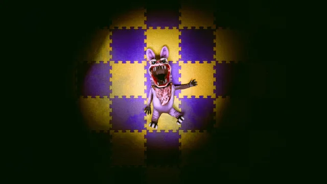 Baby Blues Nightmares screenshot: a creature in a purple bunny suit with a gaping toothed mouth, lit by a spotlight on a checkered play mat