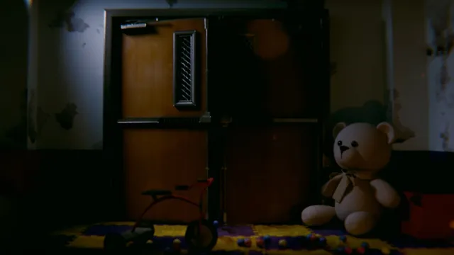 Baby Blues Nightmares screenshot: a teddy bear and a small tricycle beside a closed door in a dim room