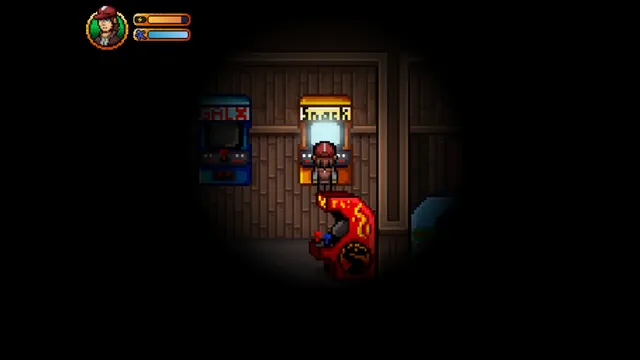 Jez plays an arcade machine in a dark games room lit only by the screens