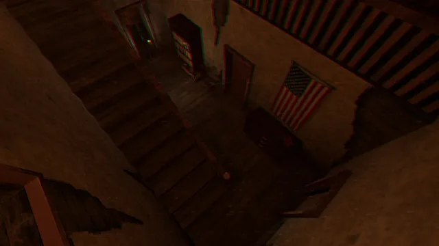 A high fixed camera looks down a wooden staircase in a decaying farmhouse with a US flag on the wall