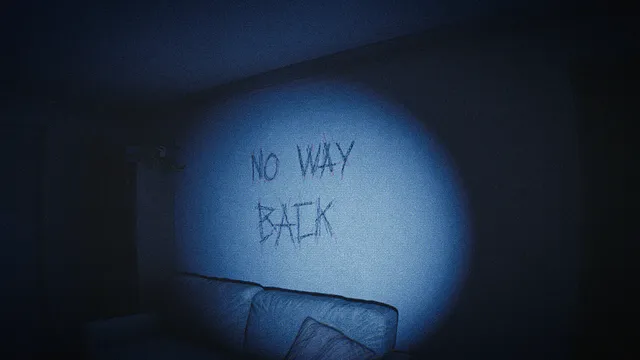The words NO WAY BACK scrawled on a living room wall above a sofa, lit by a flashlight