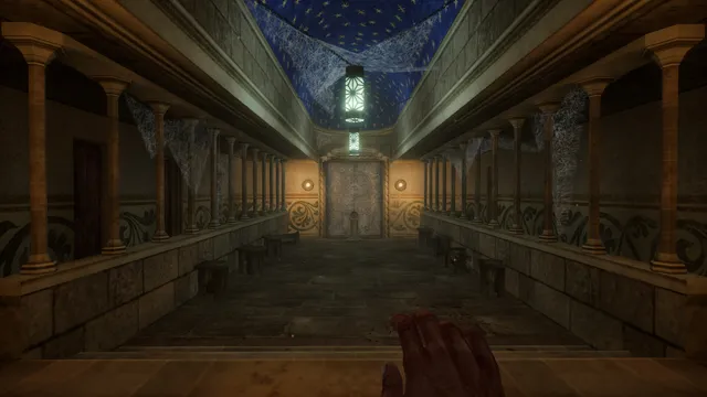 A columned hall in the tower under a starry painted ceiling, leading to a lit door