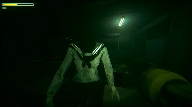 A faceless figure in a sailor school uniform stands in a dark classroom lit green