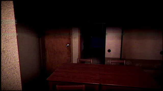 A dim apartment room with a wooden table and a sliding door left ajar