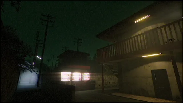 The apartment block beside a street at night, with glowing vending machines and power lines