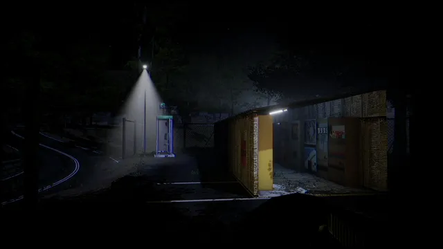 A lone phone booth under a streetlight beside a roadside shelter in the dark hills