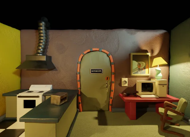 Clay-Scape! screenshot: a clay kitchen with a stove and an old computer, and a door marked ROTOSCOPE