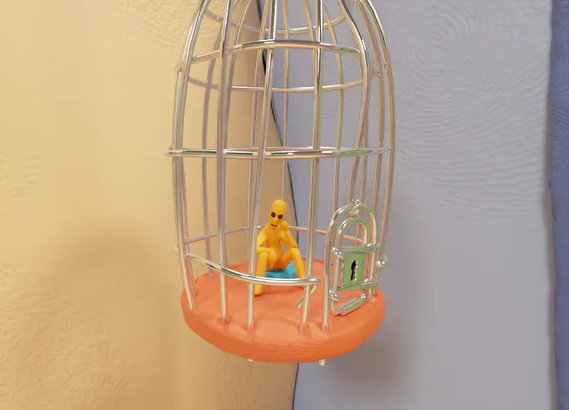 Clay-Scape! screenshot: a small yellow clay figure sits locked inside a silver birdcage