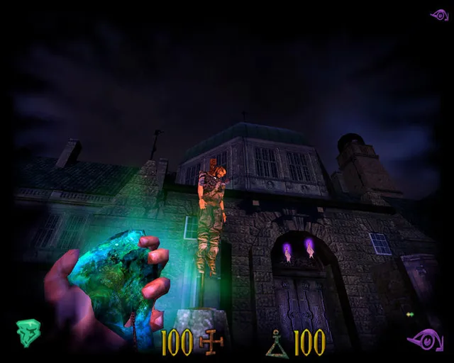 Clive Barker's Undying screenshot: a dark stone mansion at night with a body strung up on a post before its door