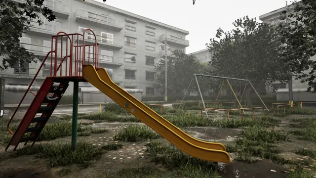 A red and yellow slide in the empty park, apartment blocks behind on a grey day