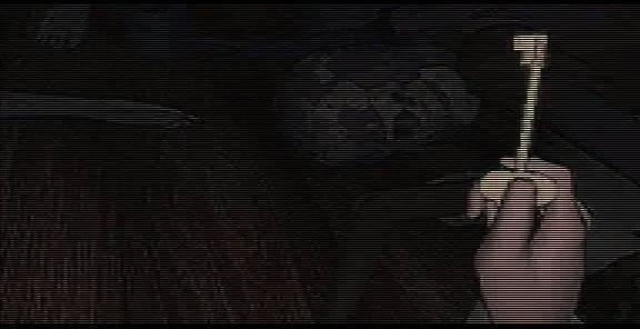 D: The Game screenshot: Laura's hand holds up a brass key in a dark room