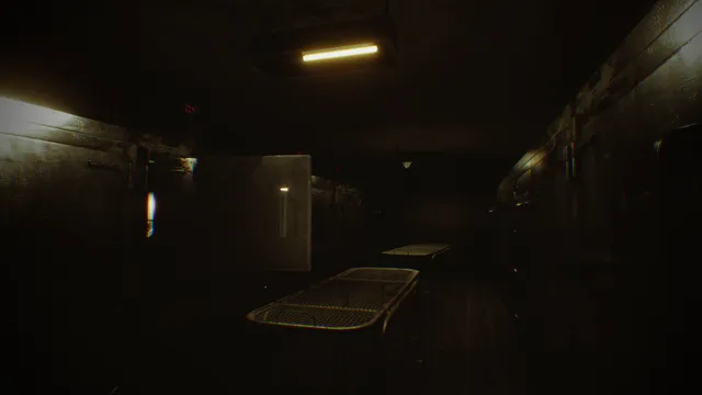 A dark body farm cold room with an open mortuary drawer and empty metal body trays under a single strip light