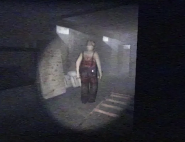 Deadly Night screenshot: a flashlight beam finds the killer standing in a dark, dusty hallway