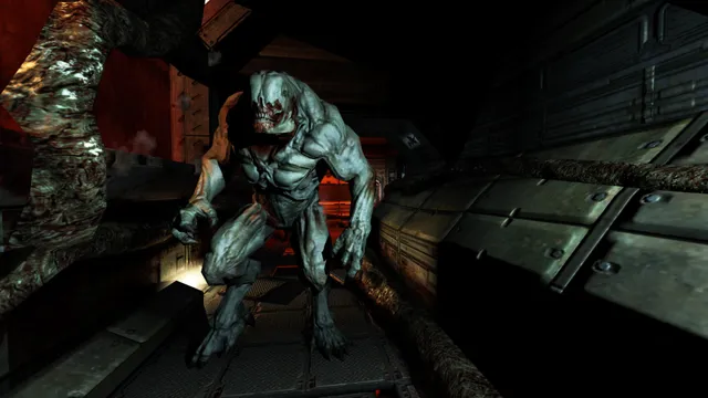 A hulking pale demon walks through a dark, organic-looking passage