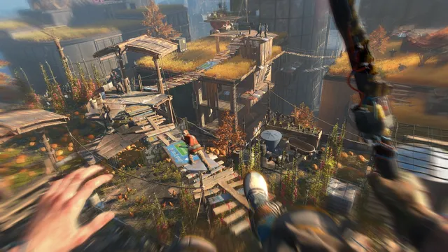 Dying Light 2 screenshot: mid-leap over rooftop gardens and plank walkways in first person, with a grappling arm