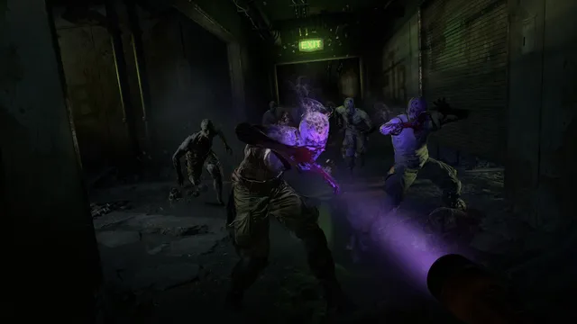Dying Light 2 screenshot: a UV flashlight lights infected lunging out of a dark tunnel under an exit sign
