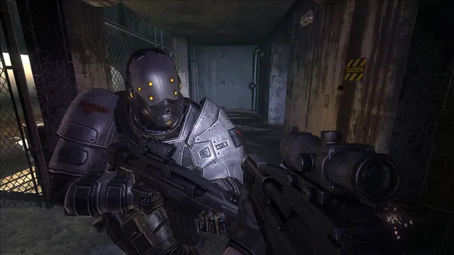 F.E.A.R. 2: an armoured enemy soldier with a glowing visor raises a rifle in a dim industrial corridor