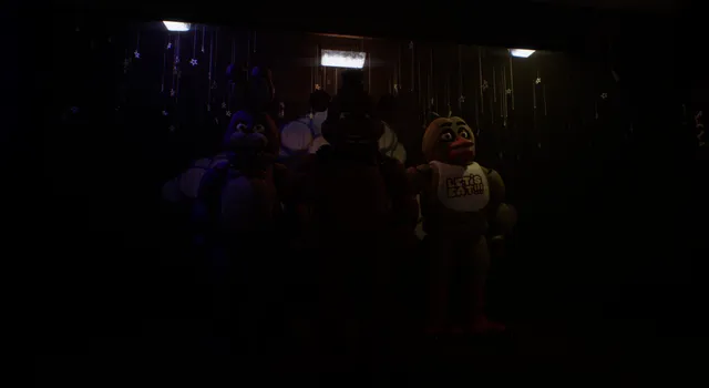 The security office: a desk with monitors, a fan, a bulletin board and a CELEBRATE poster of the animatronics