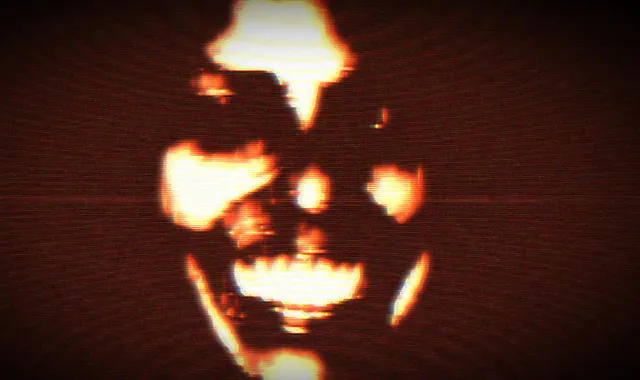 FEAR ASSESSMENT screenshot: a grinning, blurred face lit orange and red out of darkness on a CRT screen