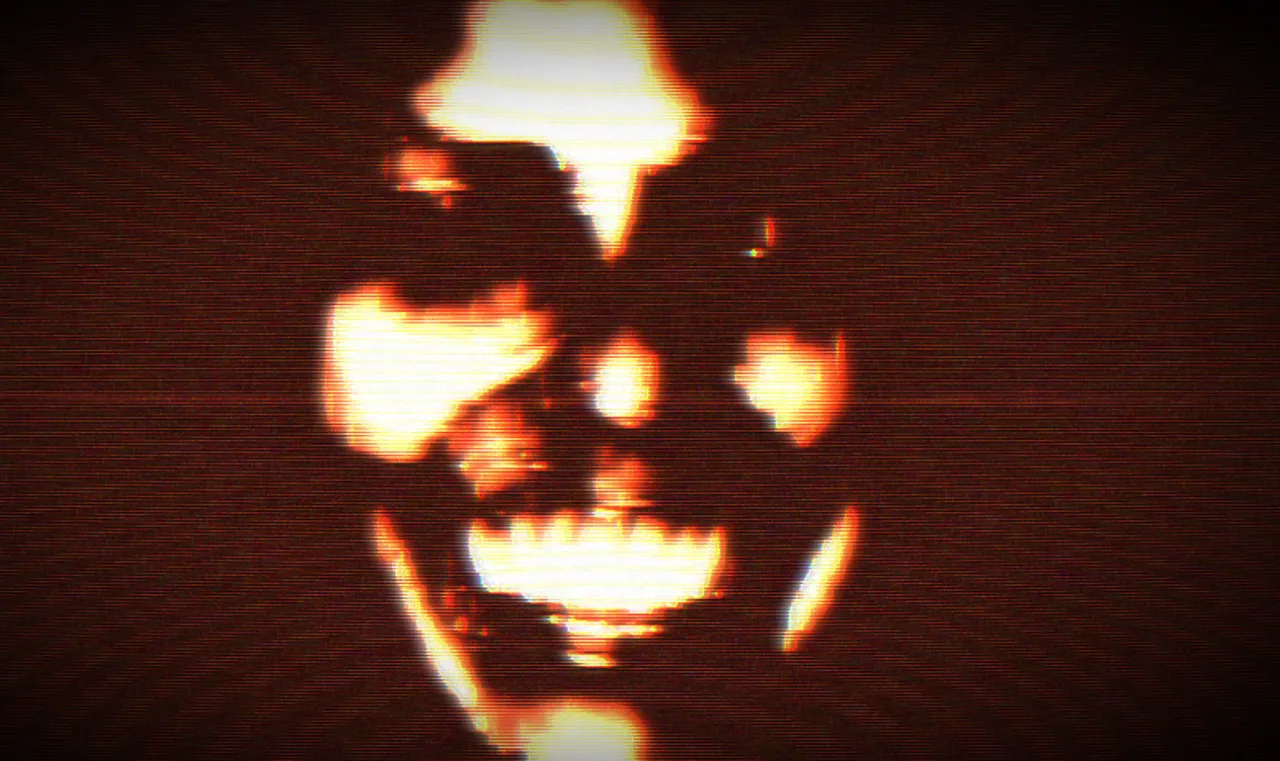 FEAR ASSESSMENT screenshot: a grinning, blurred face lit orange and red out of darkness on a CRT screen