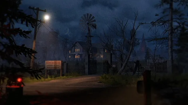 A dark country road at night leading to a fenced old house with a windmill and a sign by the gate