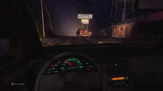 View from the driver's seat at night, pulling into a motel car park behind a pickup