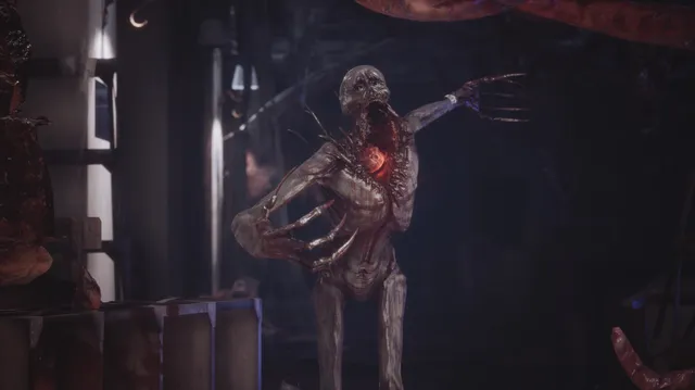 Fobia - St. Dinfna Hotel screenshot: a gaunt grey creature with clawed hands and a glowing red chest lunges in a dark storeroom