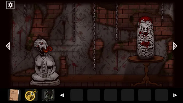 A pale statue with its tongue hanging out and a bloodied idol stand in a cellar of chains and splattered blood
