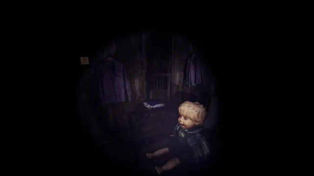 A flashlight beam picks out an old blond doll sitting below shirts hung on a wooden wall