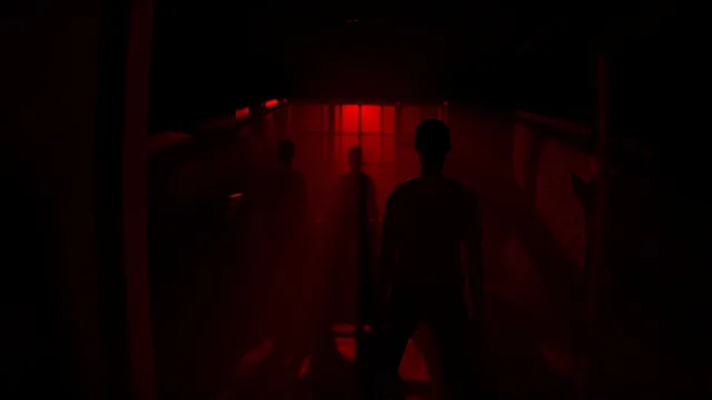 Dark human silhouettes stand in a corridor lit deep red
