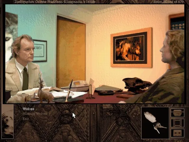 Gabriel Knight 2 screenshot: a filmed scene of a man in a tan suit at his desk in a zoo office, talking about wolves