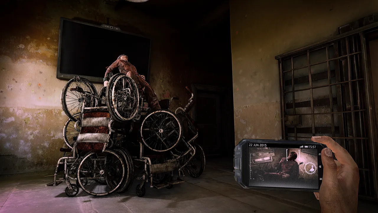 A body draped over a pile of old wheelchairs under a dark TV in a decaying asylum room, a phone held up in the foreground
