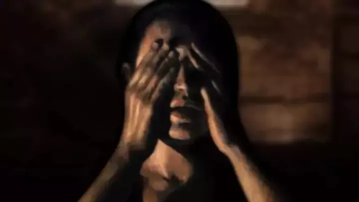 Goliath The Soothsayer art: a shadowy man covering his eyes with both hands in a dim, sepia room