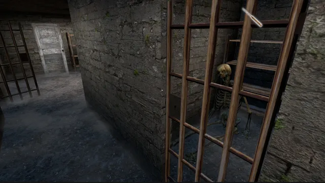 A skeleton behind wooden bars in a stone cellar of the mansion