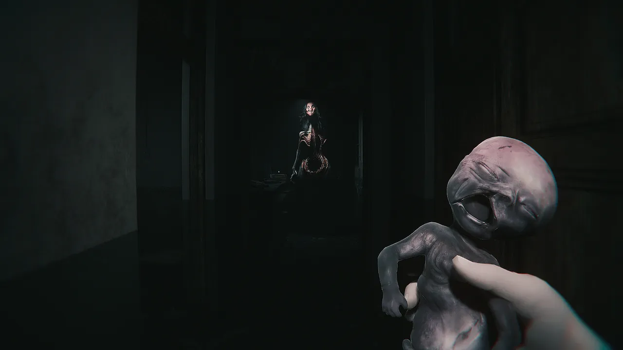 A first-person hand holds a grey, fetus-like doll while a pale figure waits in a dark doorway behind it