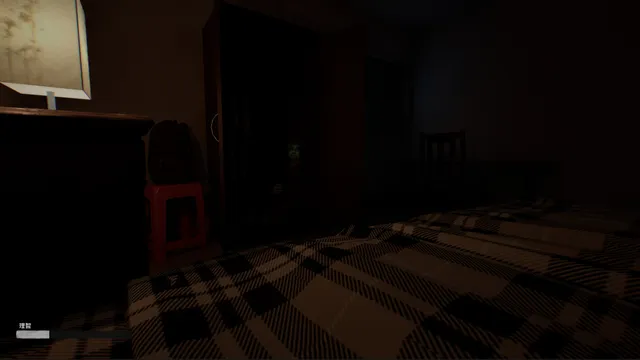 A dim bedroom with a checked bedspread, a lamp and a red plastic stool