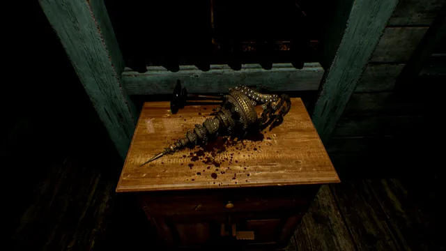 An ornate golden ceremonial object lying in spilled blood on a wooden table