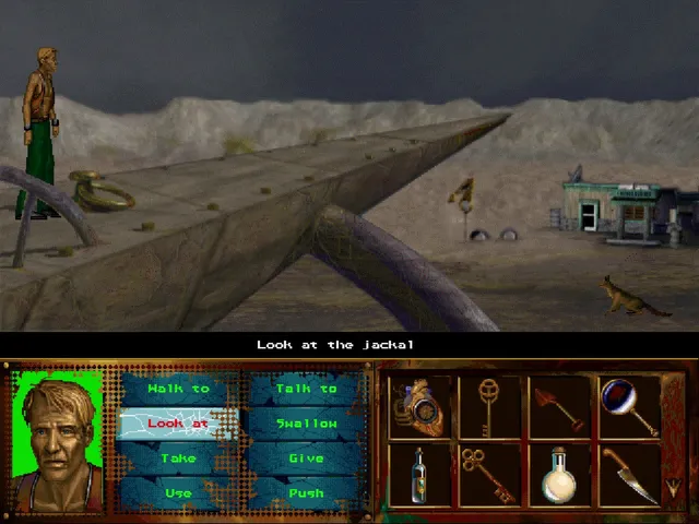 A man stands on a giant fallen structure in a grey desert with a jackal and a ruined gas station