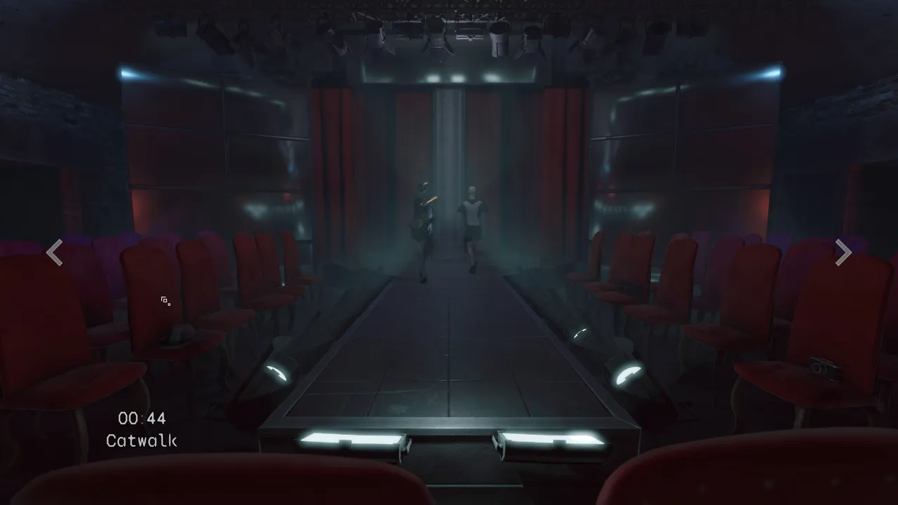 Camera view labelled Catwalk: two figures stand at the end of a dim fashion runway between rows of red seats