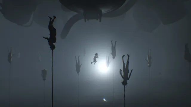 Underwater, the boy swims toward a bright light among bodies hanging upside down on cords