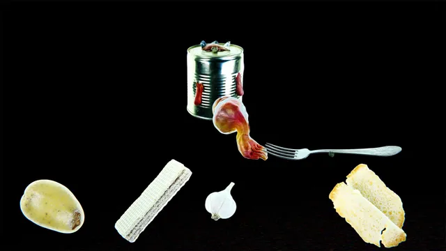 Isolomus screenshot: a clay creature crawling out of a tin can onto a fork, among a potato, bread and garlic