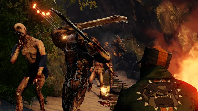 Killing Floor 2 screenshot: blade-armed Zeds lunge at a mercenary beside a fire in a cave