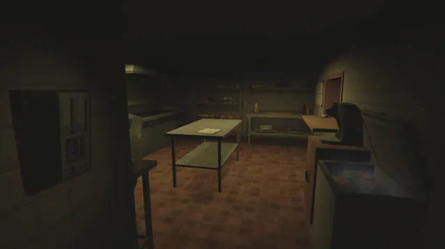 The kiosk kitchen in near darkness, with a steel table, a coffee machine and a chest freezer